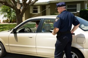 Policeman pulling over a motorist on the street due to DWI